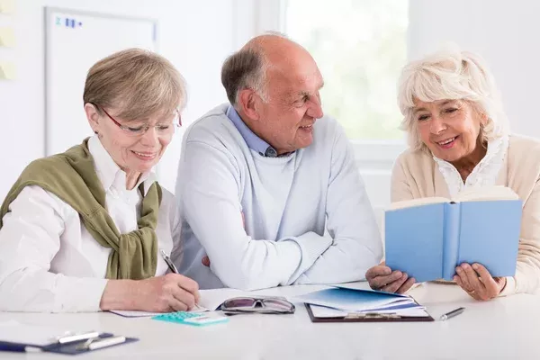 depositphotos_75065949-stock-photo-happy-retirees-studying